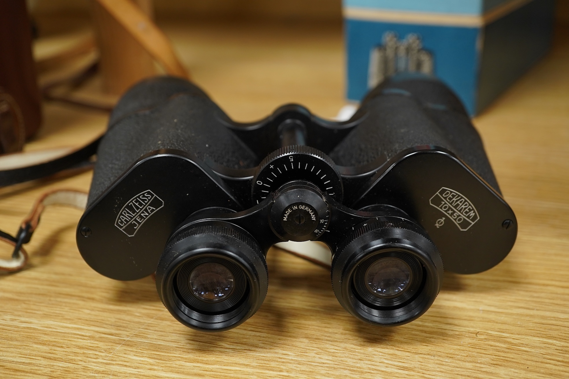 A leather cased telescope, a Zeiss Ikon camera and cased Zeiss Decarem 10 x 50 binoculars- 20cm high plus original box, 20cm high